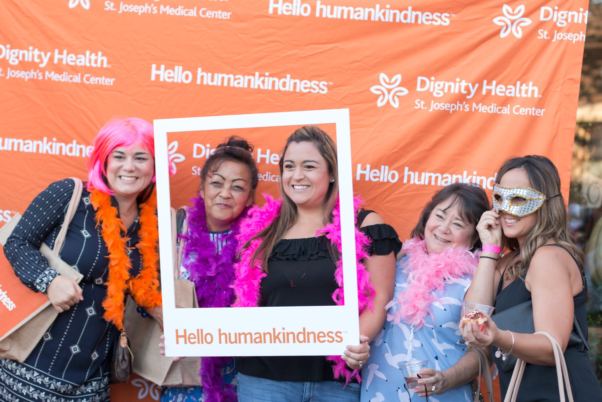 Group of women dressed in pink posing in front of Dignity Health Step and Repeat
